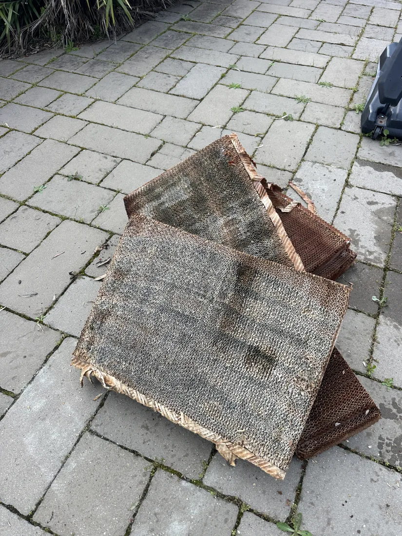 Worn evaporative cooling pads removed from a cooler